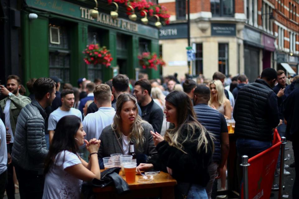 People sit and drink at the Borough Market (Reuters)