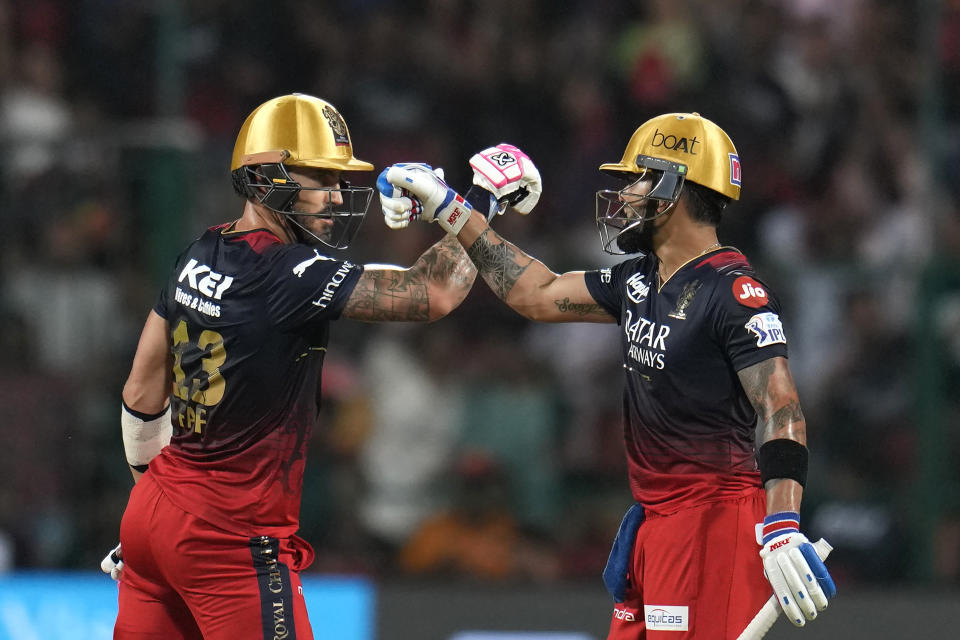 Royal Challengers Bangalore's Virat Kohli, right, celebrates with batting partner Faf du Plessis after scoring fifty runs during the Indian Premier League cricket match between Royal Challengers Bangalore and Lucknow Super Giants in Bengaluru, India, Monday, April 10, 2023. (AP Photo/Aijaz Rahi)