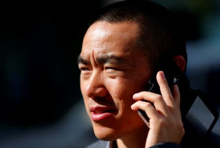 Yan Ding, a Chinese immigrant to Hungary who received an EU residency permit through the purchase of a special 300,000 euro government bond, talks on his phone in Budapest September 28, 2016. REUTERS/Laszlo Balogh