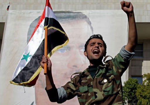 A Syrian soldier shouts slogans in front of a picture of President Bashar al-Assad during a pro-regime rally in Damascus on December 2. Syria said on Monday it conditionally accepts observers as part of an Arab plan, as a rights group reported militiamen loyal to the regime killed 34 civilians and dumped their bodies in a city square