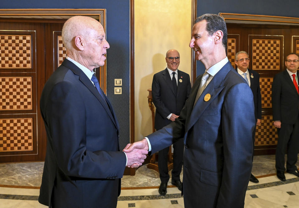 In this photo provided by the Tunisian Presidency, Tunisian President Kais Saied, left, shakes hand with Syrian President Bashar Assad, in Jeddah, Saudi Arabia, during the Arab summit, Friday, May 19, 2023. (Slim Abid/Tunisian Presidency via AP)