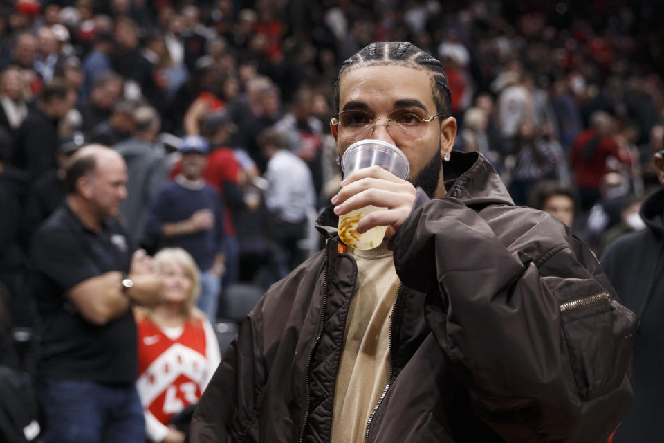 Drake drinking beer. 