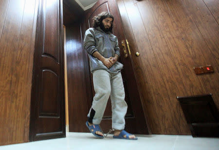 Former bakery worker Walid Ismail walks with his ankles shackled during an interview with Reuters in a Kurdish security compound in the city of Erbil, Iraq November 28, 2016. REUTERS/Azad Lashkari