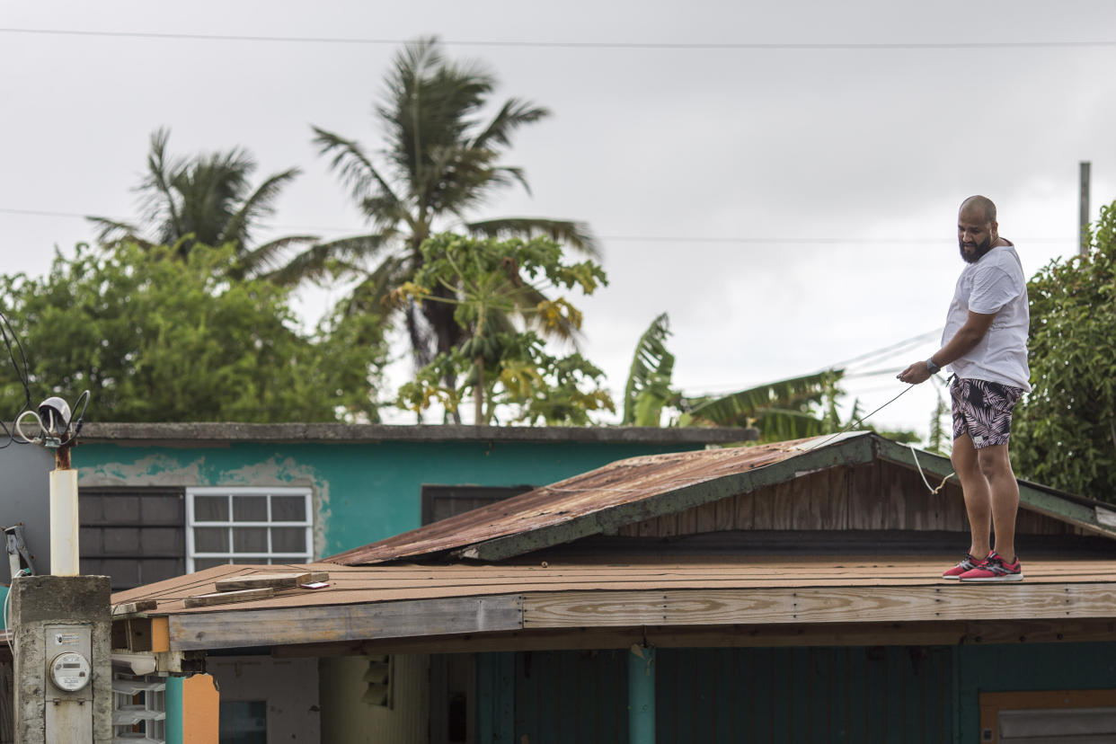 Lemuel Otero, 40, battening down the roof at his property in Maternillo, Fajardo, as Puerto Rico prepares to be hit by Tropical Storm Dorian on Wednesday, Aug. 28. (Photo: Dennis M. Rivera Pichardo for HuffPost)