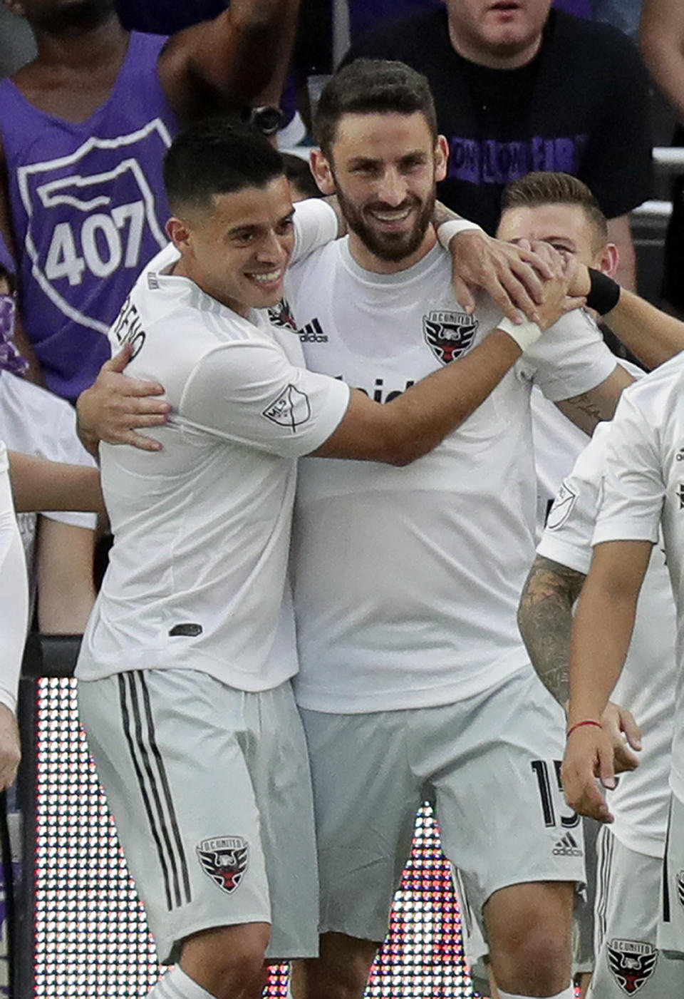 D.C. United's Junior Moreno, left, hugs Steve Birnbaum after he scored a goal against Orlando City during the first half of an MLS soccer match, Sunday, March 31, 2019, in Orlando, Fla. (AP Photo/John Raoux)