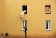 RNPS - PICTURES OF THE YEAR 2013 - A woman takes pictures of art installation "Alice" by Spanish artist Cristina Lucas in the Andalusian Centre of Contemporary Art in the Andalusian capital of Seville, southern Spain April 10, 2013. REUTERS/Marcelo del Pozo (SPAIN - Tags: SOCIETY TPX)