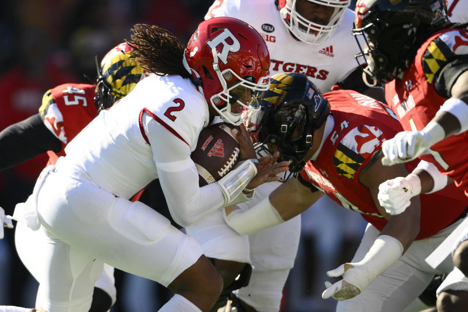 Rutgers quarterback Gavin Wimsatt (2) runs with the ball against Maryland defensive lineman Ami Finau (54) during the first half of an NCAA college football game, Saturday, Nov. 26, 2022, in College Park, Md. (AP Photo/Nick Wass)