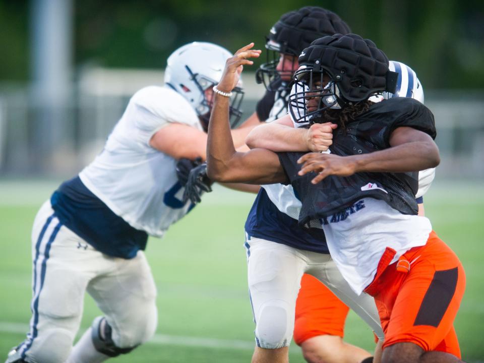Powell defender Steven Soles (6) fights through a blocker during the Farragut and Powell scrimmage at Powell High School on Friday, Aug. 6, 2022.
