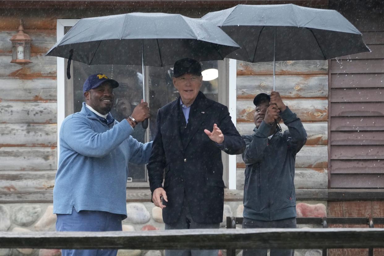 President Joe Biden poses for a photo with Hurley "HJ" Coleman IV and his father, Hurley Coleman III, left, as he arrives for a campaign event at Pleasant View Golf Club in Saginaw, Mich., Thursday, March 14, 2024.