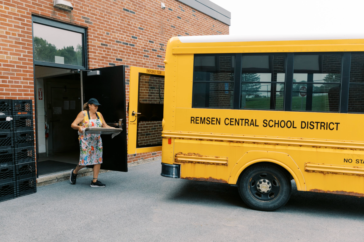 As pictured: a local volunteer loads food onto a Remsen Central School bus.