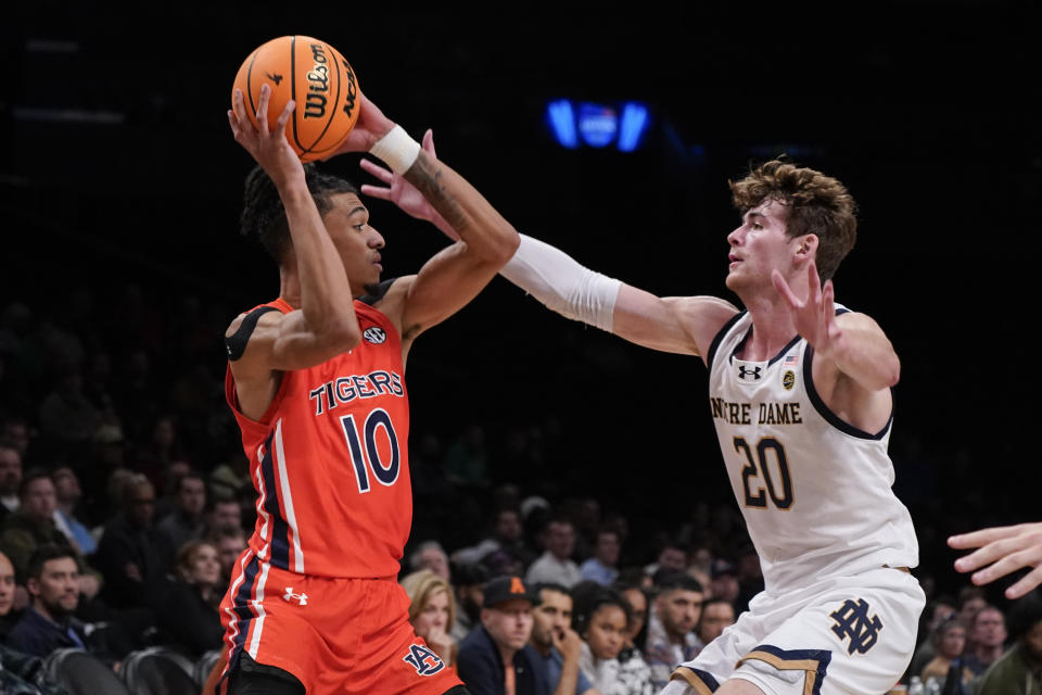 Auburn guard Chad Baker-Mazara (10) is defended by Notre Dame guard J.R. Konieczny (20) during the first half of an NCAA college basketball game in the Legends Classic tournament in New York, Thursday, Nov. 16, 2023. (AP Photo/Peter K. Afriyie)