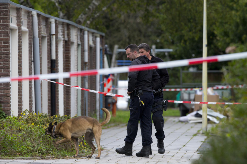 FILE - In this Wednesday, Sept. 18, 2019 file photo, forensic experts search for evidence in the area where a lawyer who represented a key witness in a major Dutch organized crime trial was gunned down in Amsterdam, in Amsterdam, Netherlands. Two men were convicted Monday, Oct. 11, 2021 and sentenced to 30 years for the murder of a Dutch lawyer who represented a witness in a high-profile criminal case against suspected gangland bosses, a slaying that shocked the nation and sparked calls for a tougher crackdown on organized crime. (AP Photo/Peter Dejong, file)