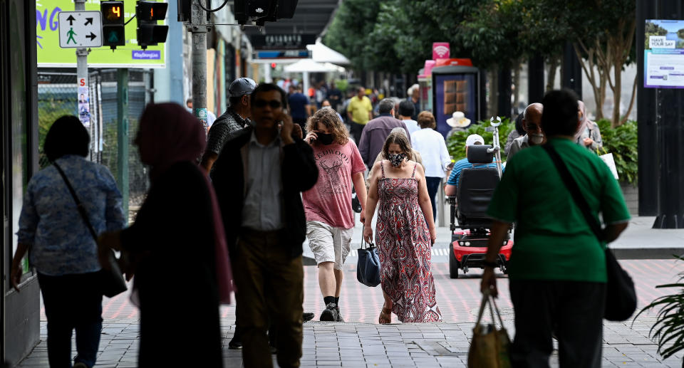 Members of the public wear face masks as they go about their daily lives in Liverpool, Sydney, Thursday, December 2, 2021. Source: AAP