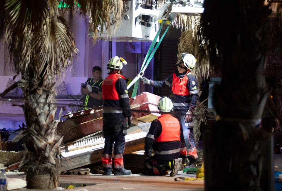 Emergency crews work after a two-storey building collapsed (AFP via Getty Images)