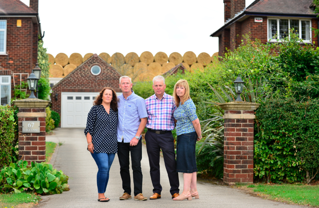 <em>Homeowners in Ockbrook are furious with the giant wall of hay behind their properties (SWNS)</em>