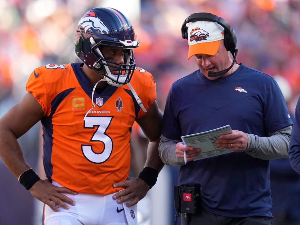 Russell Wilson and Nathaniel Hackett discuss a play against the Houston Texans.