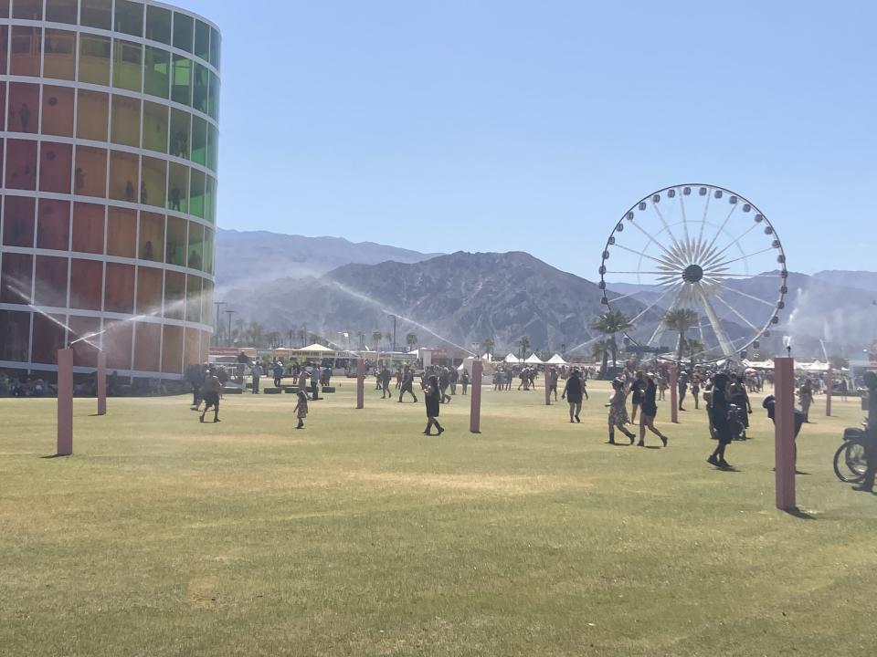 Several rotating sprinklers have been set up near Spectra at the 2023 Coachella music festival.