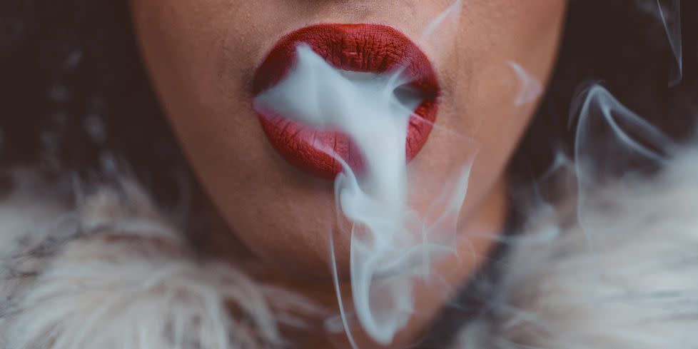woman smoking, close up on smoke and mouth