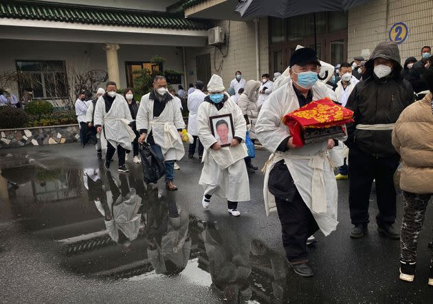 Mourners wear traditional white funeral clothing during a 2023 funeral in Shanghai, China. 
