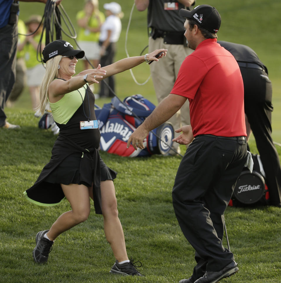 Patrick Reed, right, greets his wife Justine after winning the Humana Challenge golf tournament on the Palmer Private course at PGA West, Sunday, Jan. 19, 2014 in La Quinta, Calif. (AP Photo/Chris Carlson)