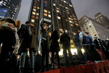 Demonstrators line a fence during a protest outside the Trump International Hotel and Tower following President-elect Donald Trump's election victory in Manhattan, New York, U.S., November 9, 2016. REUTERS/Andrew Kelly