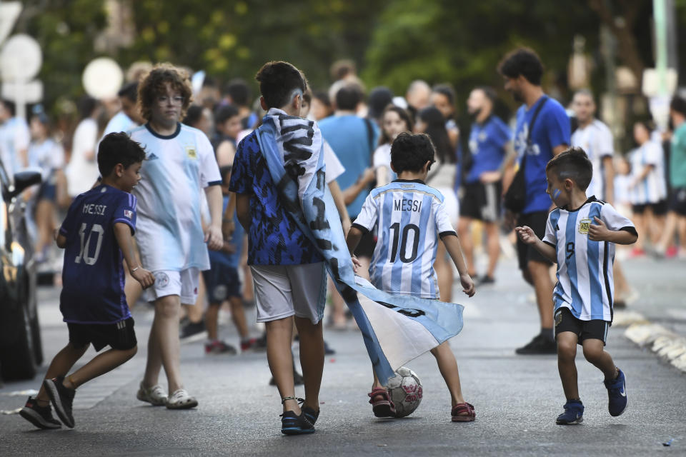 BUENOS AIRES, ARGENTINA - DECEMBER 18: Young fans of Argentina celebrate playing football in the streets after Argentina's victory against France in the final match of FIFA World Cup Qatar 2022 between Argentina and France on December 18, 2022 at Villa Urquiza neighborhood in Buenos Aires, Argentina. Argentina became World Champions of the FIFA World Cup Qatar 2022 after defeating France 4-3 in the penalty shootout. (Photo by Rodrigo Valle/Getty Images)