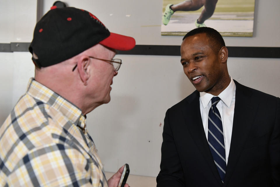 Kentucky Attorney General and Kentucky gubernatorial candidate Daniel Cameron speaks with a supporter during a campaign stop in Richmond, Ky., Wednesday, May 3, 2023. (AP Photo/Timothy D. Easley)