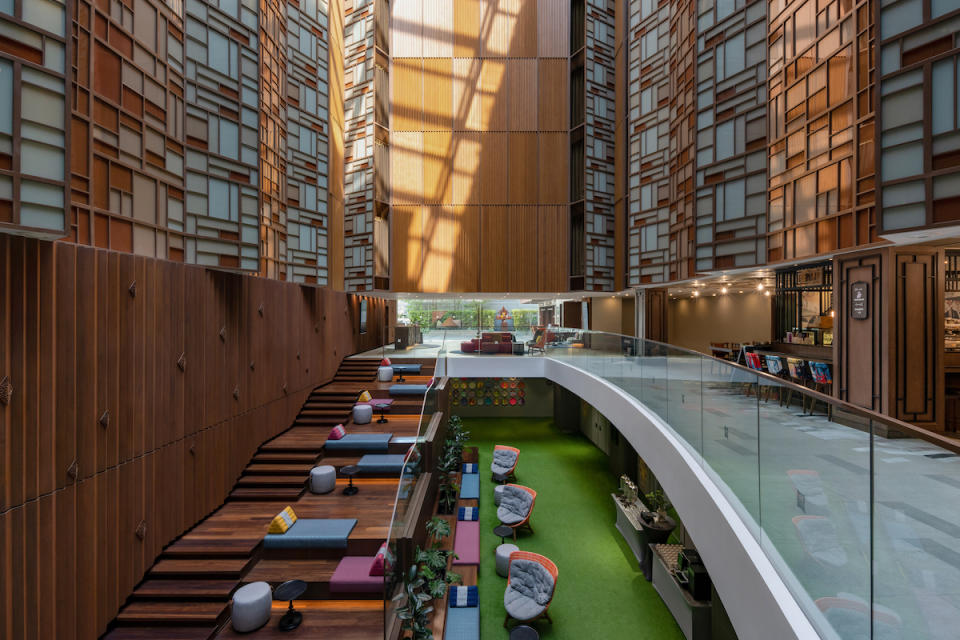 The hotel lobby features Mondrian-esque window panels and staircase space where guests can hang out. 