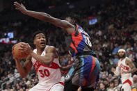 Toronto Raptors guard Ochai Agbaji (30) drives to the net as Brooklyn Nets forward Dorian Finney-Smith (28) defends during the first half of an NBA basketball game in Toronto, Monday, March 25, 2024. (Nathan Denette/The Canadian Press via AP)