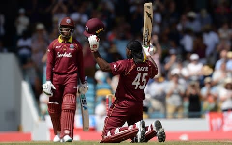 Chris Gayle celebrates hitting a century against England in February - Credit: Popperfoto
