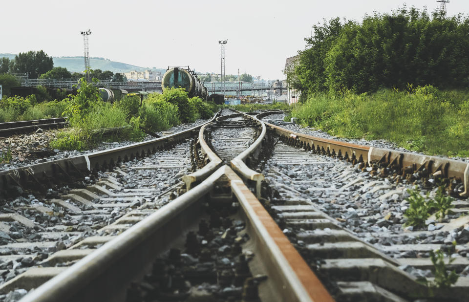 Two railways tracks merge close up.