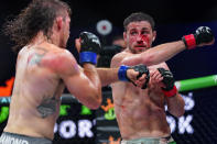 Brendan Loughnane, right, follows through on a right to Tyler Diamond during a Professional Fighters League mixed martial arts bout in Atlantic City, N.J., Thursday, June 10, 2021. (AP Photo/Matt Rourke)