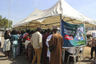 Nigeria civil servants wait to receive an AstraZeneca coronavirus vaccine, before they are allow access to their office in Abuja, Nigeria , Wednesday, Dec. 1, 2021. Nigeria has detected its first case of the omicron coronavirus variant in a sample it collected in October, weeks before South Africa alerted the world about the variant last week, the country's national public health institute said Wednesday. (AP Photo/Gbemiga Olamikan)