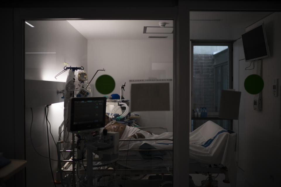 A COVID-19 patient undergoes treatment in one of the intensive care units (ICU) of the Germans Trias i Pujol hospital in Badalona, Barcelona province, Spain, Wednesday, April 1, 2020. The new coronavirus causes mild or moderate symptoms for most people, but for some, especially older adults and people with existing health problems, it can cause more severe illness or death. (AP Photo/Felipe Dana)