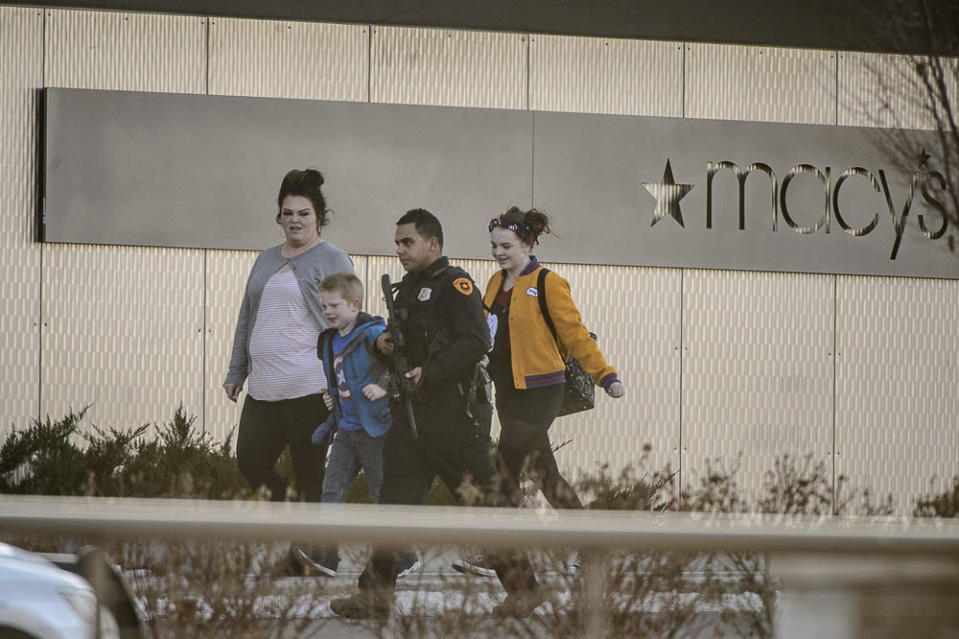 (Trent Nelson | The Salt Lake Tribune) Armed law enforcement escort people after a shooting at the Fashion Place Mall in Murray on Sunday Jan. 13, 2019.(Trent Nelson/The Salt Lake Tribune via AP)