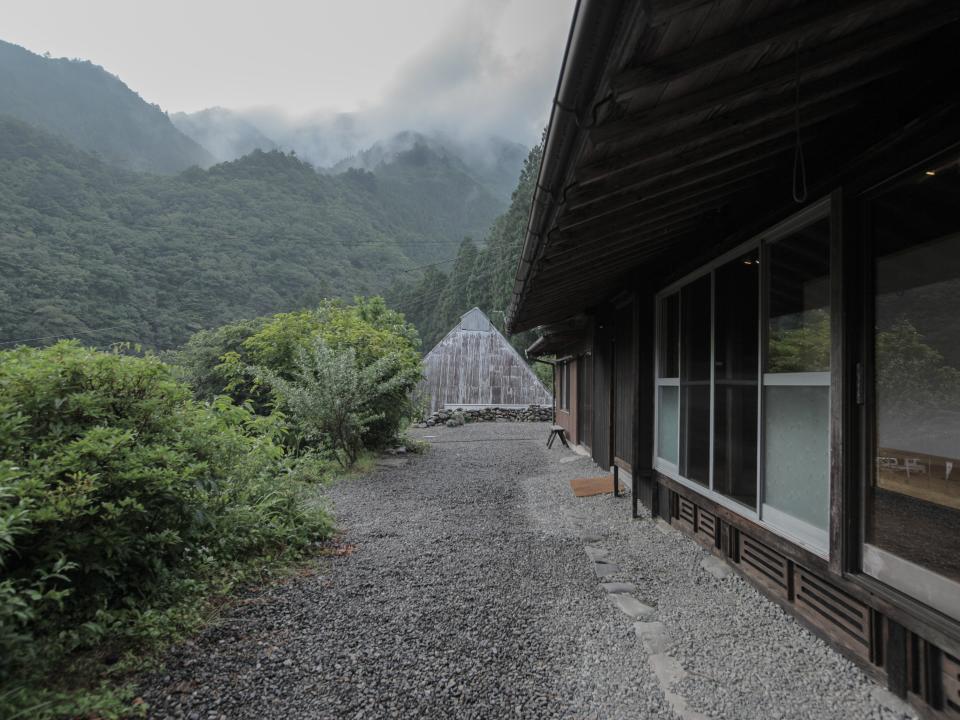 the exterior of a farmhouse in the mountains