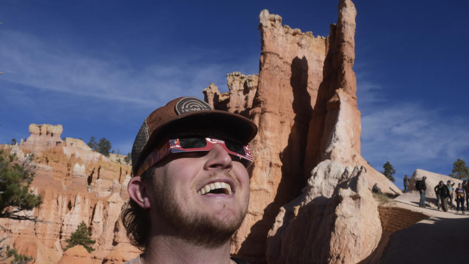 People watch the moon passes between earth and the sun during a rare "ring of fire" eclipse of the sun Saturday, Oct. 14, 2023, in Bryce Canyon National Park, Utah. (AP Photo/Rick Bowmer)