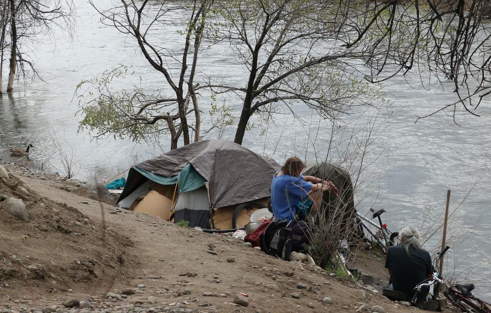 A camp for homeless people is seen along the edge of the Truckee River in Reno on April 5, 2018. The arrival of the Tesla Gigafactory has exacerbated a housing shortage in the Reno area.