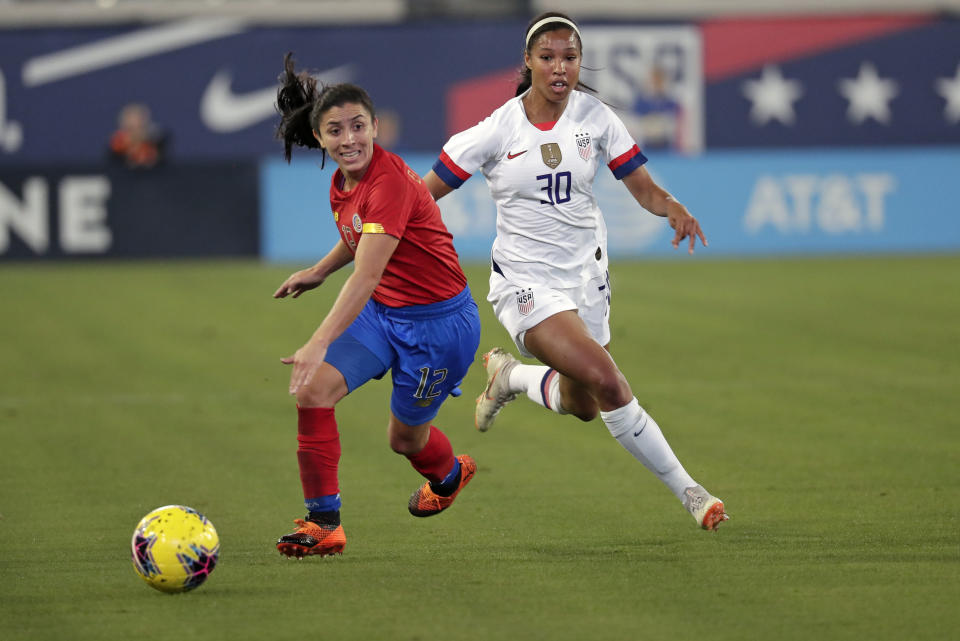 Costa Rica's Lixy Rodriguez, left, moves the ball away from U.S. forward Margaret Purce (30) during the first half of an international friendly soccer match Sunday, Nov. 10, 2019, in Jacksonville, Fla. (AP Photo/John Raoux)