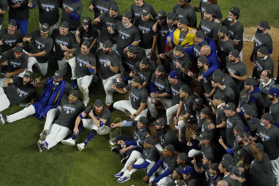 Los Angeles Dodgers manager Dave Robert and third baseman Justin Turner pose for a group picture after defeating the Tampa Bay Rays 3-1 to win the baseball World Series in Game 6 Tuesday, Oct. 27, 2020, in Arlington, Texas. (AP Photo/David J. Phillip)