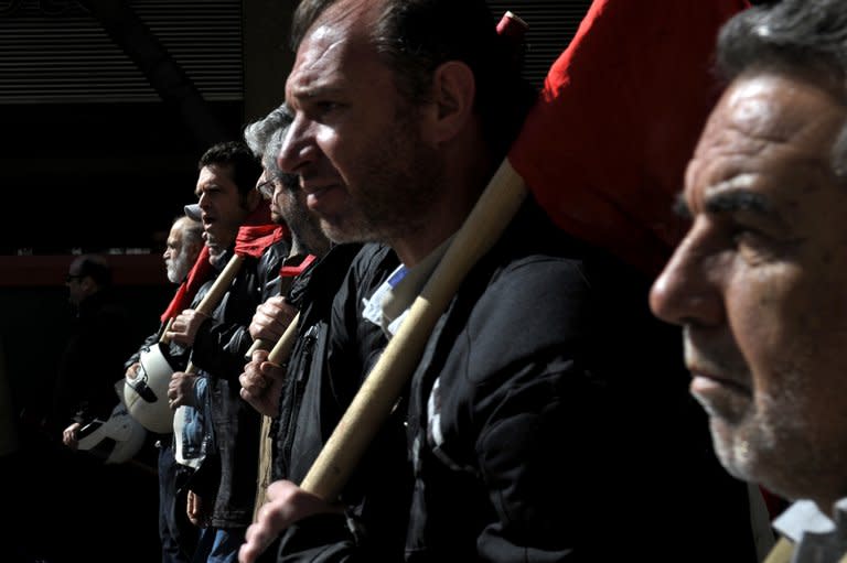 Greek workers march on February 20, 2013 during a 24-hour general strike in central Athens. About 15,000 striking workers took part in a Communist-organised demonstration in Athens and 20,000 more joined protests organised by other unions, according to police figures