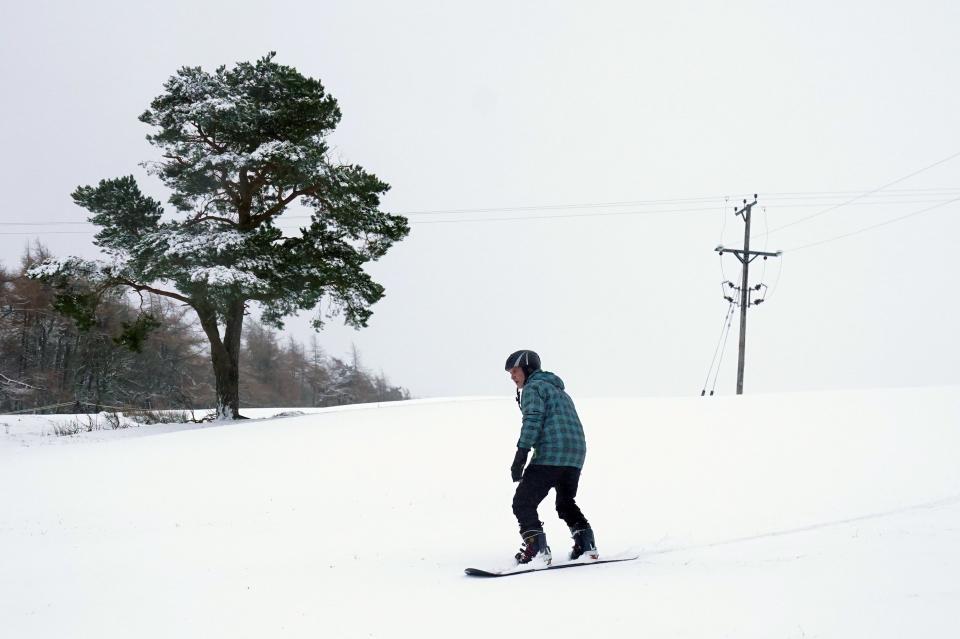 A snow boarder in Allenheads, Northumberland (PA)