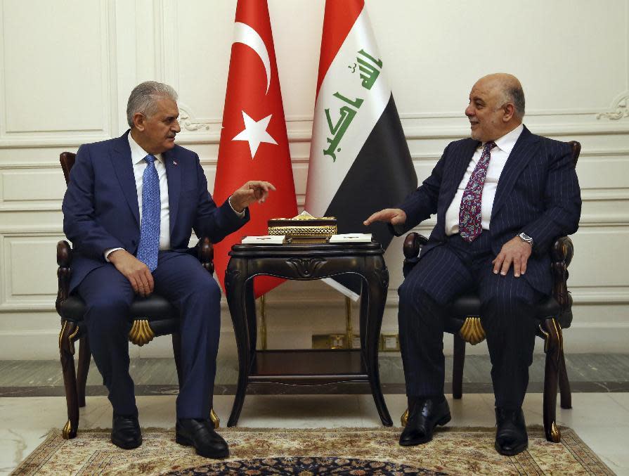 Iraq's Prime Minister Haider al-Abadi, right, and Turkish Prime Minister Binali Yildirim speak during a meeting in Baghdad, Iraq, Saturday, Jan. 7, 2017. Yildirim is in Iraq for a two-day visit. (Hakan Goktepe, Prime Minister's Press Service, Pool photo via AP)