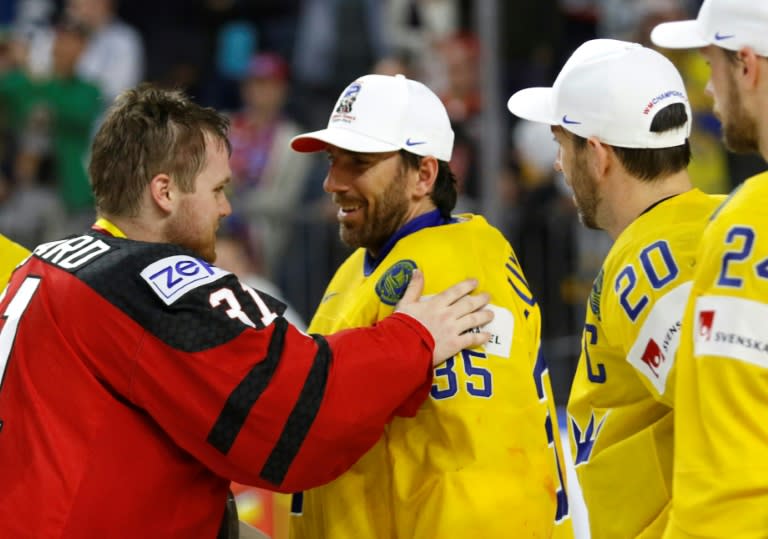Canada's goalie Calvin Pickard (L) congratulates Sweden's goalie Henrik Lundqvist on May 21, 2017