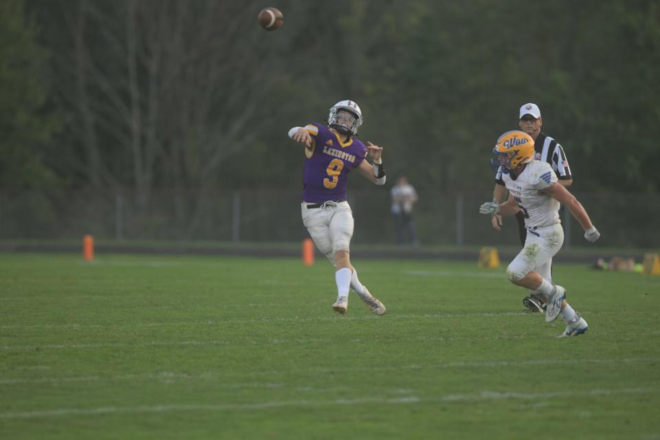 Lexington's AJ Young delivers a pass on the run during Lexington's thrilling 22-21 victory over Wooster on Friday night.