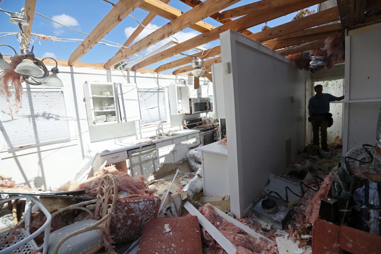 Inspecting damage to a home in Mexico Beach after Hurricane Michael in 2018.