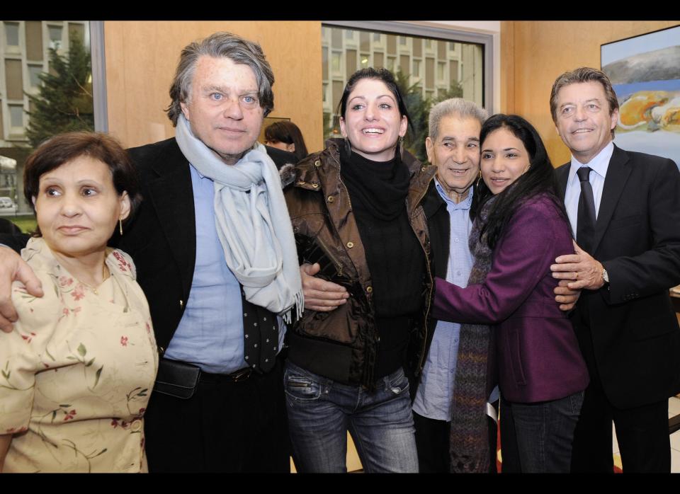 French former prisoners Celine Faye (3rdL) and Sarah Zaknoun (2ndR) pose with Sarah's parents, her mother Khedidja (L) and her father Belkacem (3rdR) as they arrive on December 30, 2009 at the Roissy Charles de Gaulle airport accompanied by French junior minister for Cooperation and Francophonie, Alain Joyandet (R) and their lawyer Gilbert Collard a day after their release from the prison in Santo Domingo. The two French women walked free from jail in the Dominican Republic yesterday thanks to a presidential pardon after 18 months behind bars for drug smuggling. Sarah Zaknoun, 19, and Celine Faye, 20, who had been sentenced to eight years in jail last year after being found with six kilograms (13 pounds) of cocaine in their luggage, spoke by telephone with French President Nicolas Sarkozy after being released following a Christmas pardon. AFP PHOTO POOL BERTRAND GUAY (Photo credit should read BERTRAND GUAY/AFP/Getty Images)