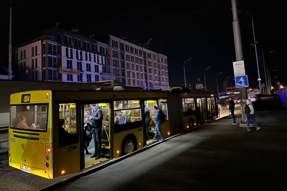 People ride a bus as street lights are off in Kyiv, Ukraine, Tuesday, Nov. 1, 2022. Rolling blackouts are increasing across Ukraine as the government rushes to stabilize the energy grid and repair the system ahead of winter.