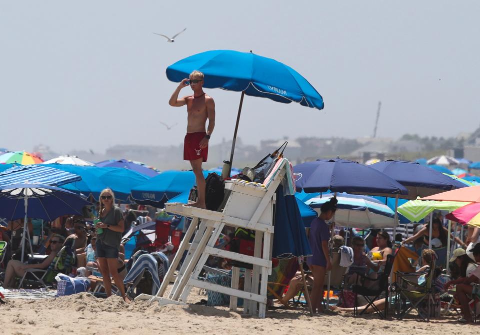 A lifeguard looks over bathers at the edge of the competition area during the Mid-Atlantic Regional Lifeguard Championships in Rehoboth Beach Wednesday, July 13, 2022.