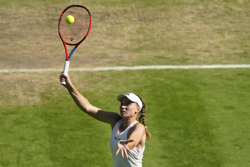 Kazakhstan's Elena Rybakina returns to Romania's Simona Halep in a women's singles semifinal match on day eleven of the Wimbledon tennis championships in London, Thursday, July 7, 2022. (AP Photo/Gerald Herbert)